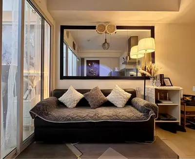 a couch in a living room with a mirror at Dream Escapade in Manila