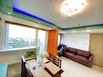 a living room with a couch and a table at Stunning view staycation near MOA PICC WORLD TRADE CENTER AIRPORT LUNETA PARK MANILA OCEAN PARK QURINO GRANDSTAND in Manila