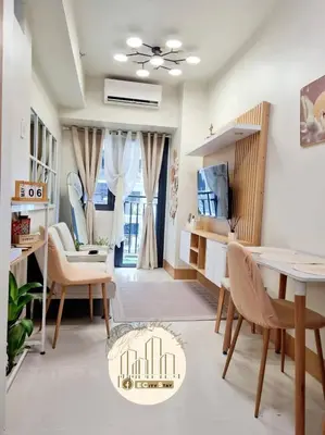 a living room with a dining room table and chairs at EcityStay in Manila