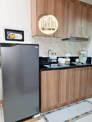 a kitchen with a refrigerator and a microwave at EcityStay in Manila