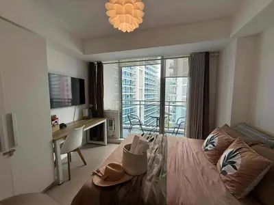 a bedroom with a bed with a hat on it at Azure Bali Verde-1Bedroom pool view in Manila