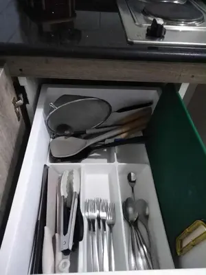 a drawer filled with utensils in a drawerlictsangering at Vistaro Stays at Fame Residences in Manila