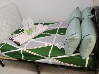 a bed with pillows on it in a room at Sea Residence Tower A by Stave in Manila