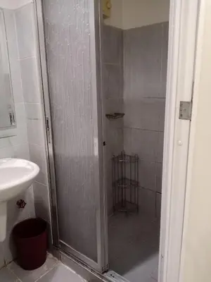 a bathroom with a shower and a sink at Sea Residence Tower A by Stave in Manila