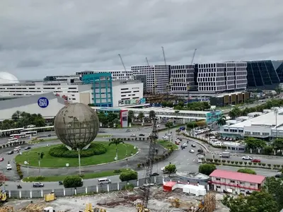 a city with a lot of traffic in front of buildings at Sea Residence Tower A by Stave in Manila