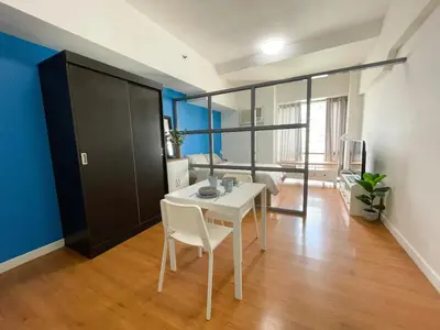 a dining room with a table and chairs in a room at 1 BR Condo in Manila near US Embassy & St Lukes in Manila