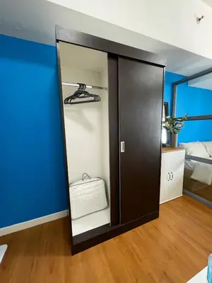a black closet with a mirror in a room at 1 BR Condo in Manila near US Embassy & St Lukes in Manila