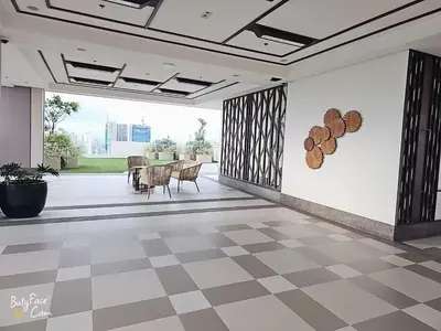 a room with a checkered floor and a table and chairs at Vtan Condo in Manila