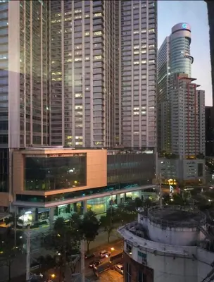 a view of a city at night with tall buildings at Lush Residence in Manila