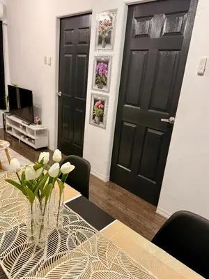 a dining room with a vase of flowers on a table at Santa Cosy Villa suite-B Fast Wi-Fi, Netflix Included Split system Air-con & Hot Shower Close to Enchanted Kingdom in Santa Rosa