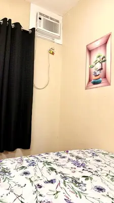 a bedroom with a bed and a window with a plant at Santa Cosy Villa suite-B Fast Wi-Fi, Netflix Included Split system Air-con & Hot Shower Close to Enchanted Kingdom in Santa Rosa