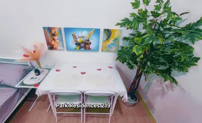 a table and a potted plant in a room at PARK RESIDENCE Unit 219, SM City Santa Rosa, Laguna, by SMDC in Ibaba