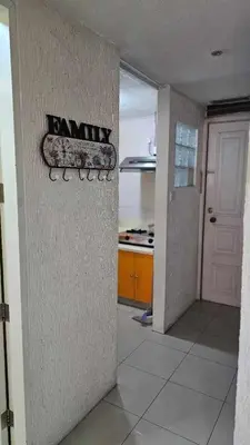 a hallway of a kitchen with a sign on the wall at Stan Condo in Manila