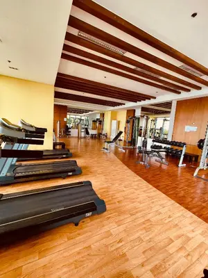 a gym with a row of treadmills in a room at Studio Unit at Grand Riviera Suites in front of US Embassy in Manila