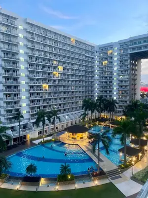 an overhead view of a large building with a large pool at Cozy Place at Shell Residences in Manila