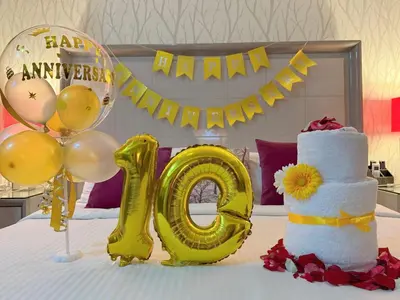 a bed with a cake and a yellow number at MaxStays - Max Home at The Venice Residences in Manila