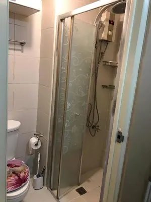 a shower with a glass door in a bathroom at 5 minutes to Jazz Mall Studio-type condo100mbps in Manila