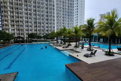 a large swimming pool in front of a large building at 5 minutes to Jazz Mall Studio-type condo100mbps in Manila