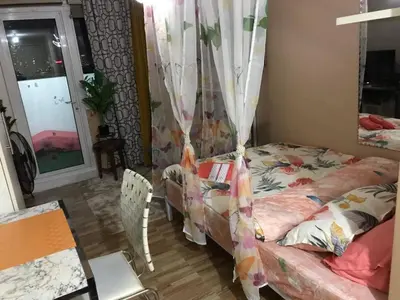 a bedroom with a bed and a table and a window at 5 minutes to Jazz Mall Studio-type condo100mbps in Manila