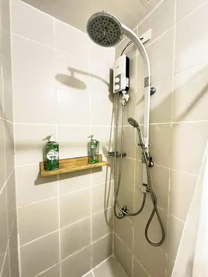 a shower with a shower head in a bathroom at Fourth's Jazz Cozy Pad in Manila