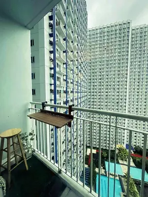 a balcony with a view of a large building at Fourth's Jazz Cozy Pad in Manila