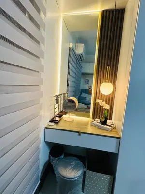 a dressing room with a mirror and a desk at KD's Home - Fast WiFi, Netflix , Pool , Karaoke in Manila