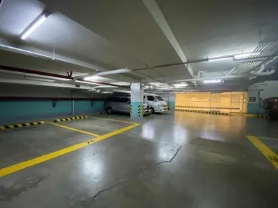 a parking garage with a car parked in it at Bekipay Suite at One Palm Tree right across NAIA 3 in Manila