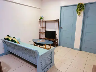 a living room with a couch and a table at Stan Condo in Manila