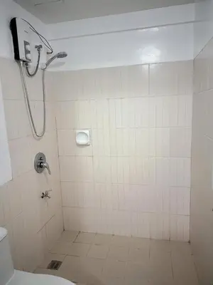 a bathroom with a shower and a toilet at Stan Condo in Manila