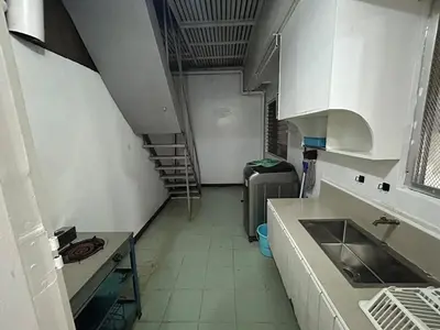 a kitchen with a sink and a staircase in a room at 4Br House in Pasay near airport in Manila