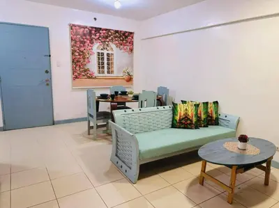 a living room with a couch and a table at Arista place staycation in Manila