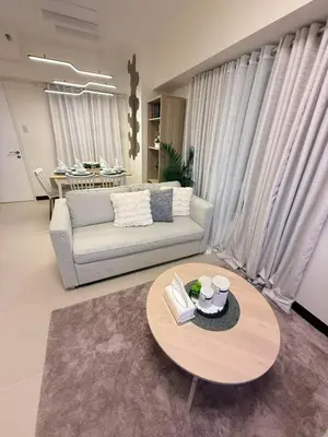 a living room with a couch and a table at The Camden Place 2BR Haven Cozy Condo Apartment Unit in Manila