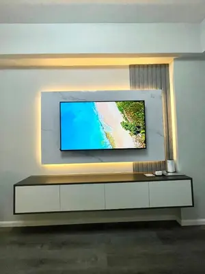 a flat screen tv on a wall in a living room at Nyli Minimalist Suite in Manila
