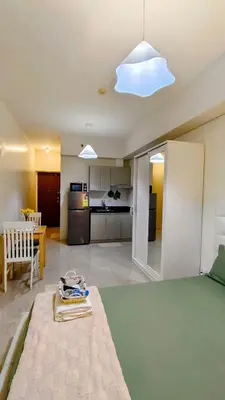 a living room with a bed and a kitchen at Bella Suite Netflix Pool Great View in Manila