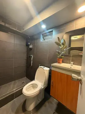 a small bathroom with a toilet and a sink at California Gardens square in Manila