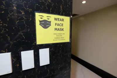 a sign that says wear a face mask in a room at Oriental Zen Suites in Manila