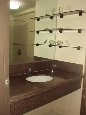 a bathroom with a sink and a mirror at Tropical Hawaiian 2BR Condo Unit in Metro Manila with Laundry Area - Sleeps 4 in Manila