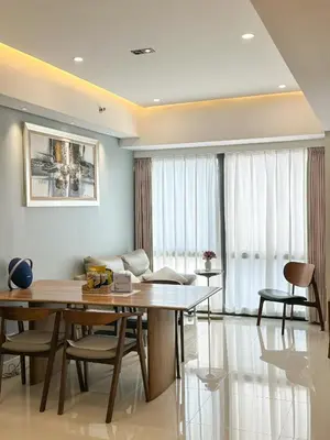 a dining room with a table and chairs and a couch at Private Apartment walk to Greenbelt, Legazpi Village in Manila