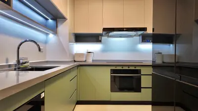 a kitchen with a sink and a stove at Private Apartment walk to Greenbelt, Legazpi Village in Manila