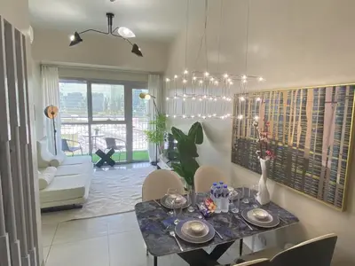 a dining room with a table and chairs in a room at Playful 1BR With Magnificant Bayview Garden View Near Okada Solaire Aiports with Free Parking in Manila
