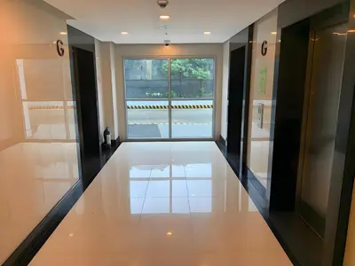 an empty hallway with a window in a building at Playful 1BR With Magnificant Bayview Garden View Near Okada Solaire Aiports with Free Parking in Manila