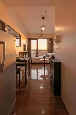a kitchen and living room with a table and a dining room at Makati Penthouse Studio with City Views in Manila