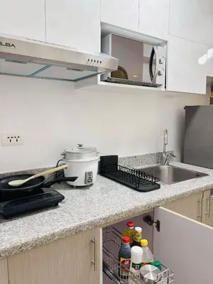 a kitchen with a sink and a counter top with a sink at Metro Stay Grand View Tower in Manila