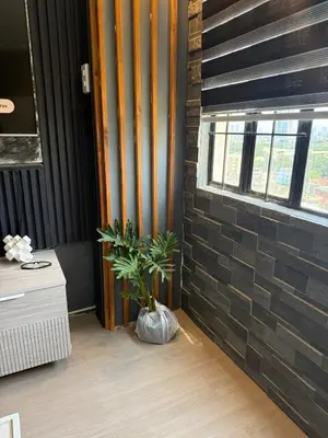 a plant in a vase next to a brick wall at 2 bedroom loft type with 2 baths Near Rockwell in Manila