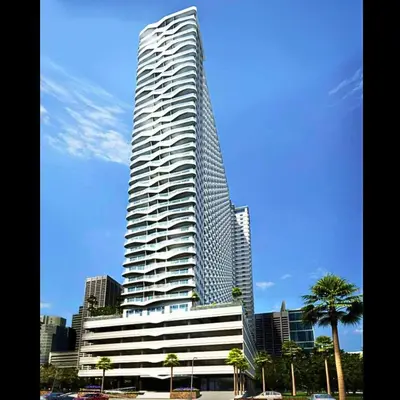 a tall skyscraperraper in front of a city at Place To Stay Near US Embassy Front Of Manila Bay in Manila
