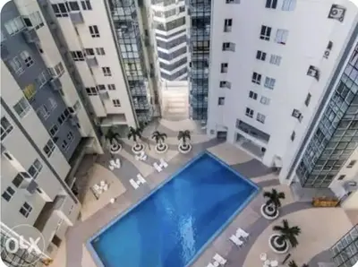 a view of a pool in the middle of some buildings at NEW AND AFFORDABLE 2BR LOFT at THE FORT BGC 200mbps WiFi in Manila