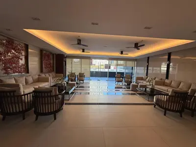 a lobby with couches and chairs in a building at Infinity Suites Makati in Manila