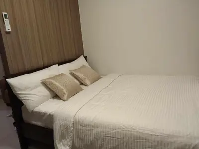 a bed with two pillows on it in a room at 1 BR- with Balcony -Shore 2 Tw2 - Pasay MOA in Manila