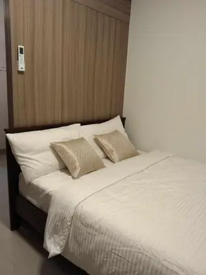 a large white bed with two pillows on it at 1 BR- with Balcony -Shore 2 Tw2 - Pasay MOA in Manila