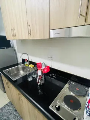 a kitchen with a sink and a counter top at Shore 2 Residences Moa Pasay in Manila